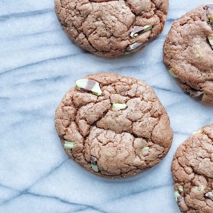 4 chocolate mint chip cookies on a marble platter