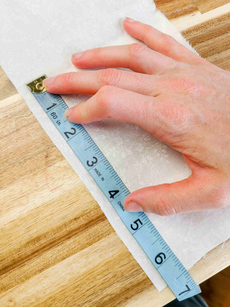 woman measuring fabric with measuring tape 
