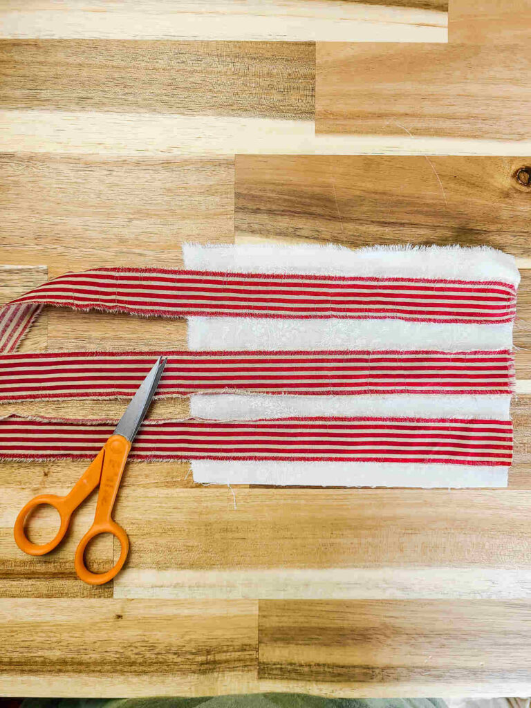 woman laying fabric out to design flag
