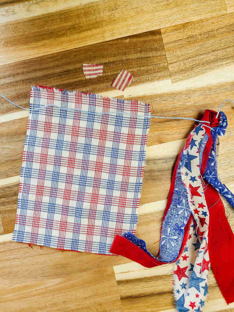 woman gluing flag on to banner
