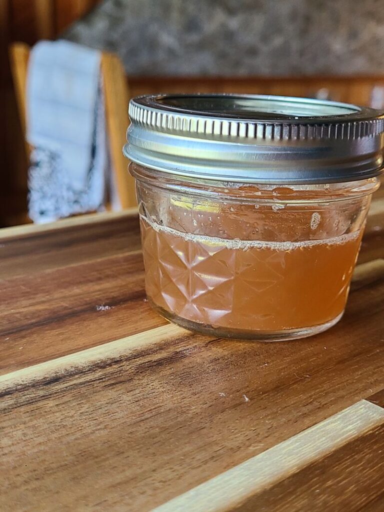 wild parsnip salt solution mixed together in 4oz. quilted mason jar sitting on wood counter