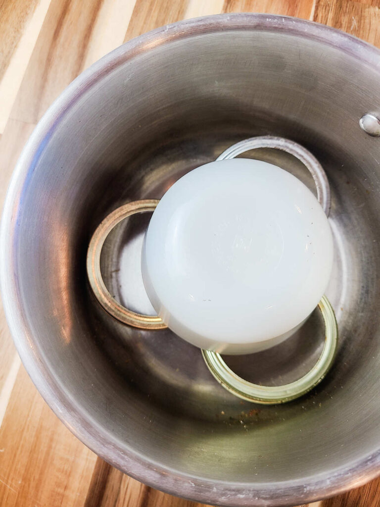 pot with jar lids and lining the bottom plus a small glass bowl to work as double boiler. 