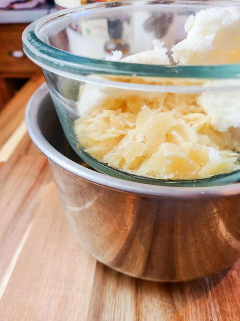 lip balm ingredients measured into glass bowl