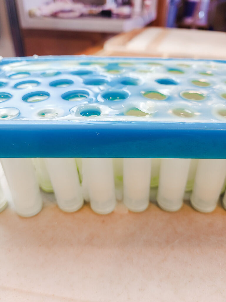 lip balm fill tray full of lip balm tubes that are filled with lip balm mixture. 