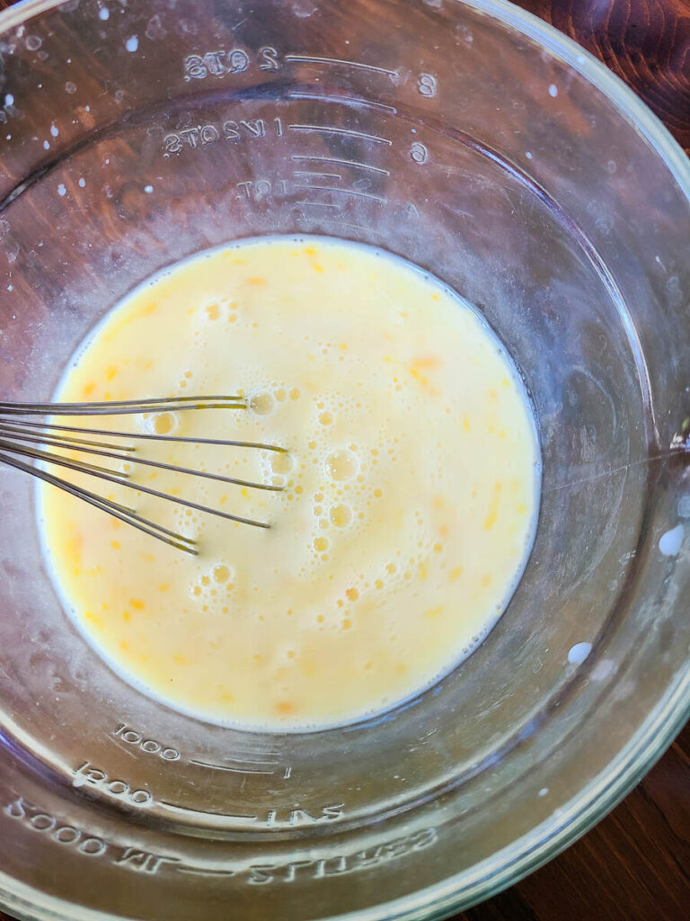 woman whisking German pancake batter together