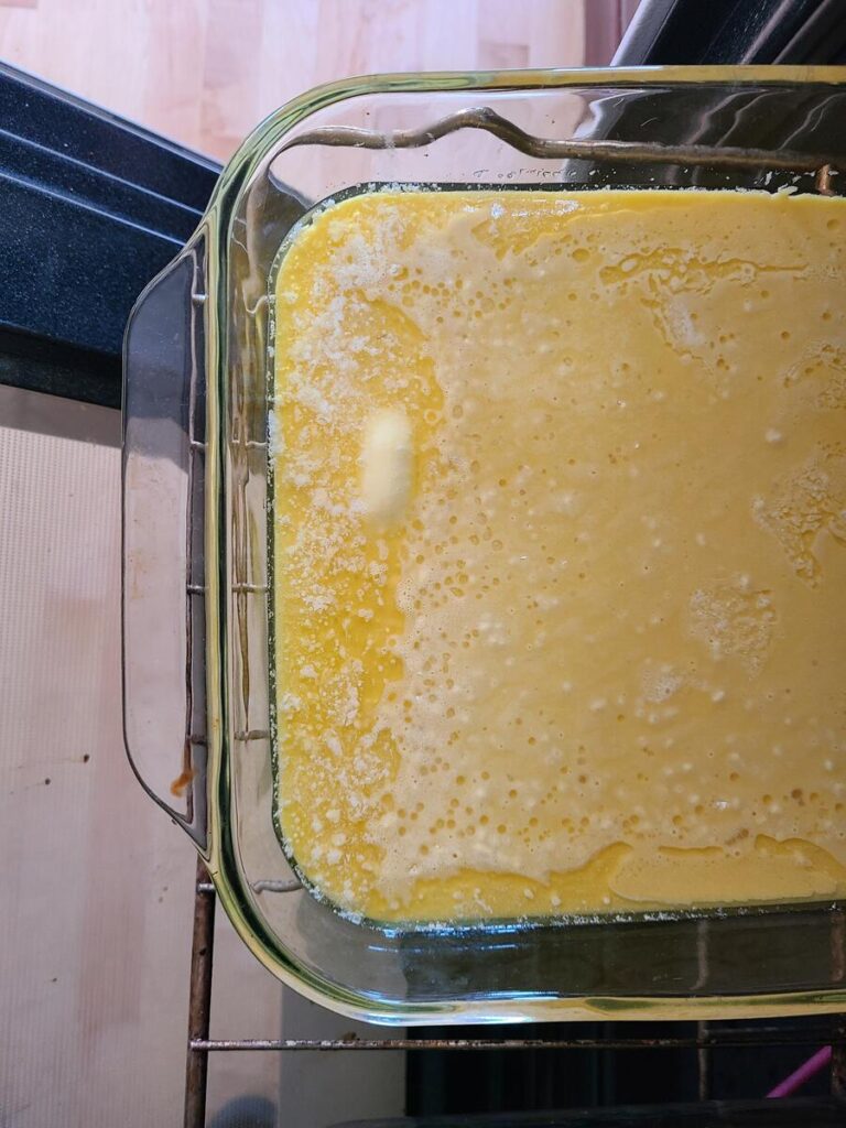 German pancake batter poured into hot pan with butter
