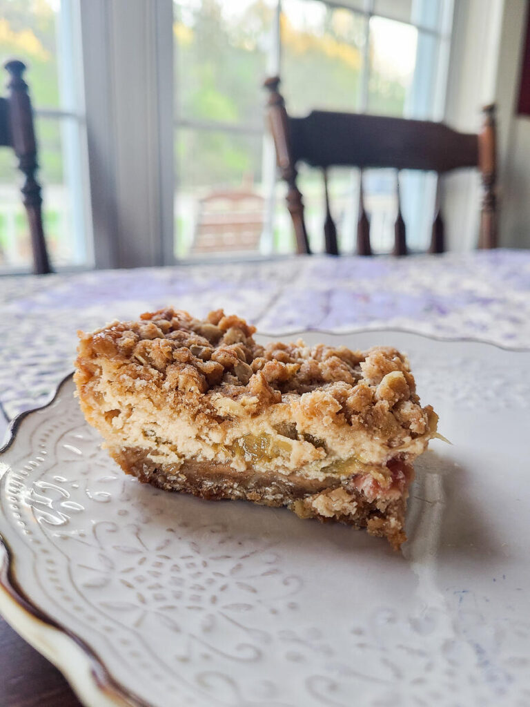 freshly sliced rhubarb cream cheese bar on white plate 