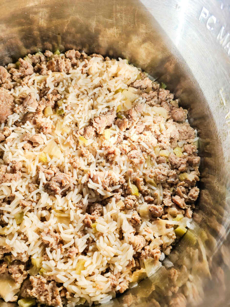 woman fluffing rice with fork