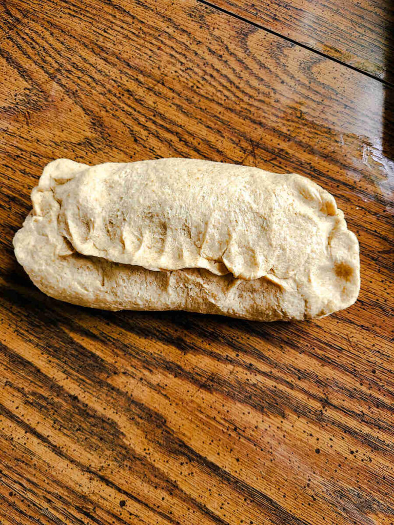 woman forming dough into loaf shape 